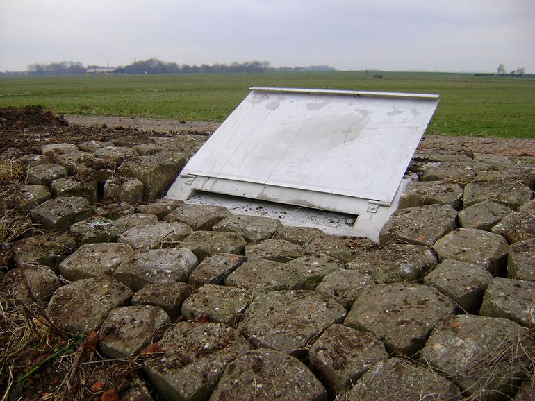 De experimentele overwinterteringsput is toegankelijk via een nauwe sleuf die kan worden afgeschermd met een metalen klep zodat net ontwaakte ringslangen niet direct open en bloot op een kale dijk komen.