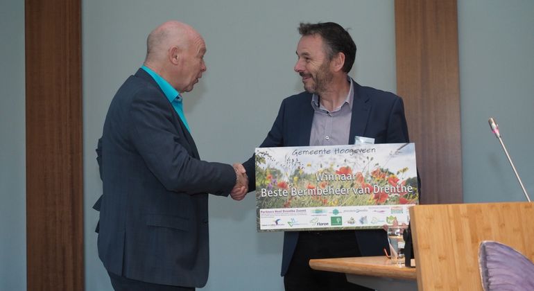 FLORON-directeur Rob van Westrienen reikt de prijs voor 'Beste Bermbeheer van Drenthe' uit aan wethouder Jan Steenbergen van de gemeente Hoogeveen