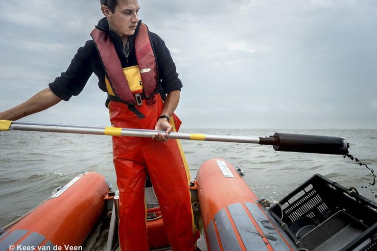 Taking a soil sample from the boat to determine sediment composition and biodiversity of benthic life