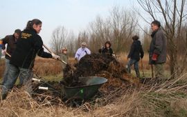 Vrijwilligers leggen een nieuwe broeihoop aan