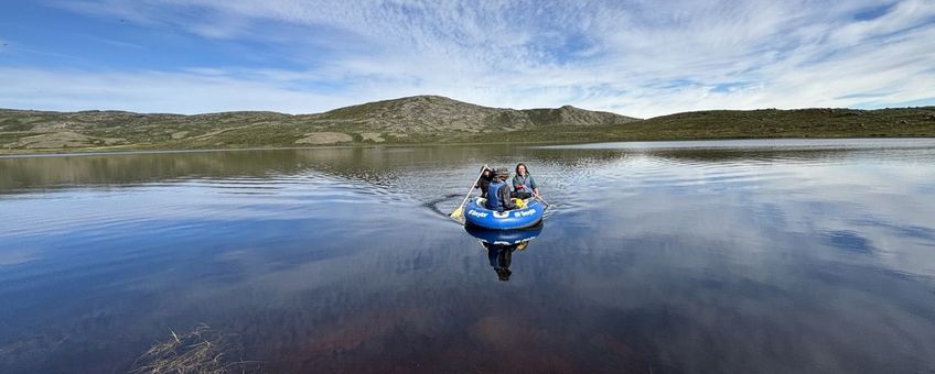 Researchers in a boat sample a lake near Kangerlussuaq, Greenland, that browned after the extreme events.