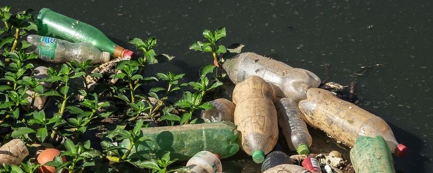 Plastic afval drijvend in rivier