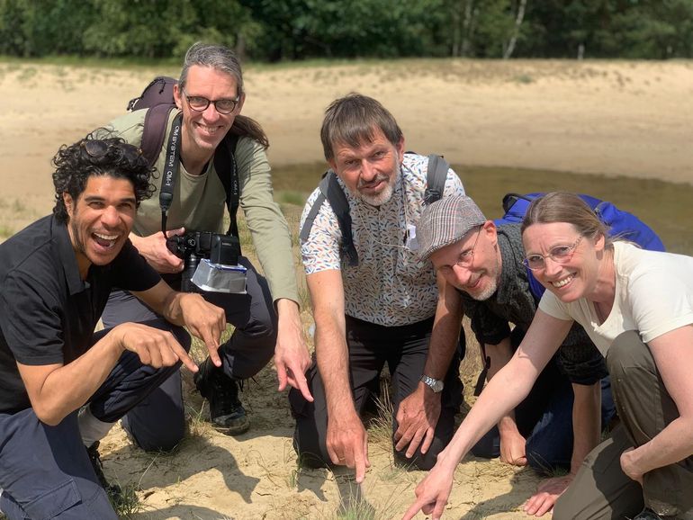 De excursie naar de winnaar van 2024 heeft succes gehad. Maurice Lede, Frans Bouma, Jan Wieringa, Elmar Veerman en Aglaia Bouma wijzen trots naar de veldkrekel die ze net hebben gevonden